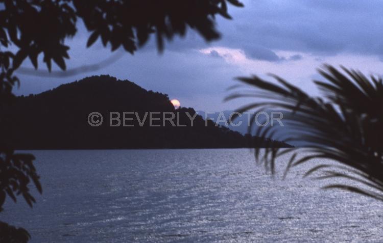 Island;Sunset;sky;clouds;sun;water;red;palm trees;sillouettes;ocean;fiji